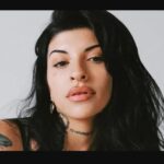 Cazzu performing on stage during a live concert, related to Cazzu net worth and music career