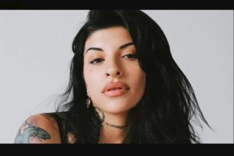 Cazzu performing on stage during a live concert, related to Cazzu net worth and music career