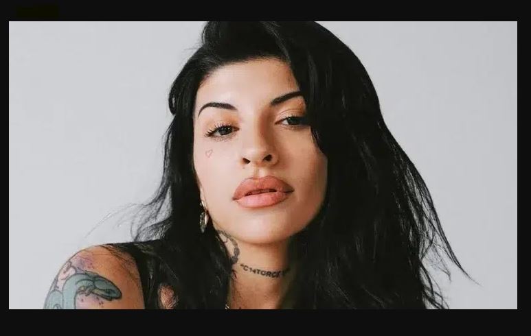 Cazzu performing on stage during a live concert, related to Cazzu net worth and music career